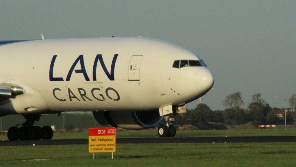 A white lan cargo airplane on a runway.