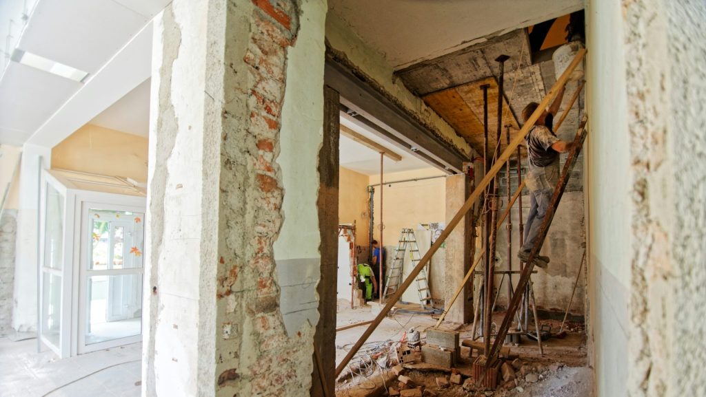 man climbing on ladder inside room