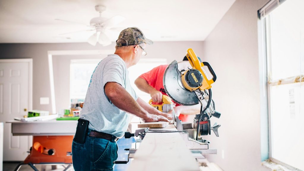 man standing infront of miter saw